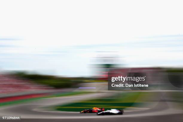 Daniel Ricciardo of Australia driving the Aston Martin Red Bull Racing RB14 TAG Heuer passes Sergey Sirotkin of Russia driving the Williams Martini...