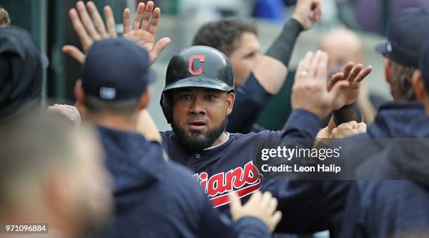 Melky Cabrera of the Cleveland Indians celebrates in the dugout after scoring on the double to center field by Erik Gonzalez during the sixth inning...