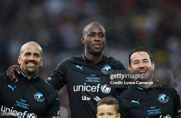 Juan Sebastian Veron of the Rest of the World, Yaya Toure of the Rest of the World and Martin Compston of the Rest of the World look on prior to the...