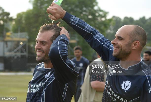 Kyle Coetzer pours beer on Calum MacLeod after Scotland won the One-Day International match between Scotland and England at Grange cricket club...