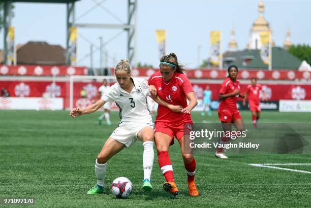 Kathrin Hendrich of Germany battles for the ball with Shelina Zadorsky of Canada during the first half of an International Friendly match at Tim...