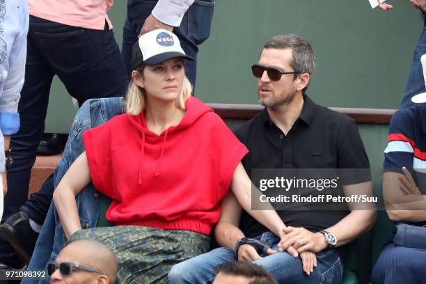Actors Marion Cotillard and husband Guillaume Canet attend the 2018 French Open - Day Fifteen at Roland Garros on June 10, 2018 in Paris, France.