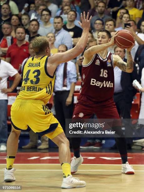 Stefan Jovic of FC Bayern Muenchen competes with Luke Sikma of ALBA Berlin during the third play-off game of the German Basketball Bundesliga finals...