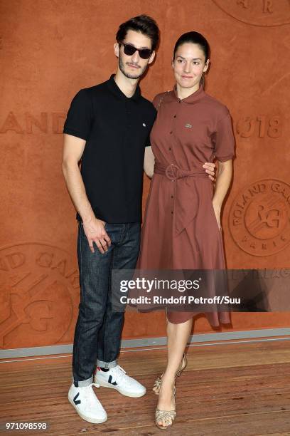 Actors Pierre Niney and Natasha Andrews attend the 2018 French Open - Day Fifteen at Roland Garros on June 10, 2018 in Paris, France.