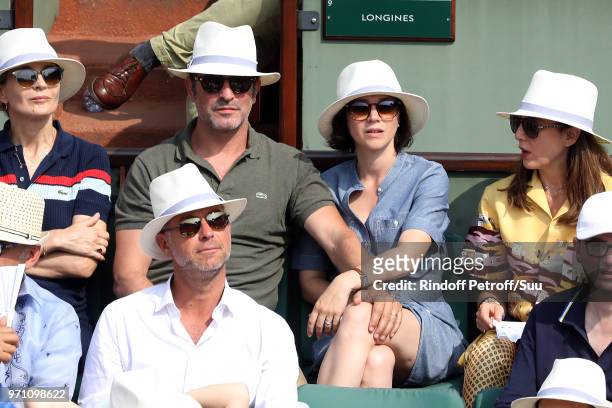 Actor Jean Dujardin and his wife Ice kater Nathalie Pechalat attend the 2018 French Open - Day Fifteen at Roland Garros on June 10, 2018 in Paris,...