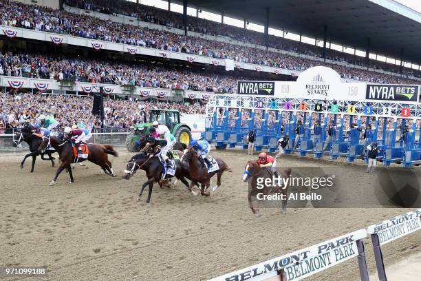 Justify, ridden by jockey Mike Smith breaks from the gate during the 150th running of the Belmont Stakes at Belmont Park on June 9, 2018 in Elmont,...