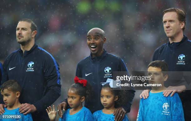 Paddy McGuinness of England, Sir Mo Farah of England and Damian Lewis of England look on prior to the Soccer Aid for UNICEF 2018 match between...
