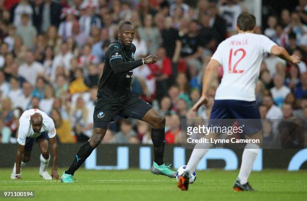 Usain Bolt of the Rest of the World takes on Sir Mo Farah of England and Phil Neville of England during the Soccer Aid for UNICEF 2018 match between...