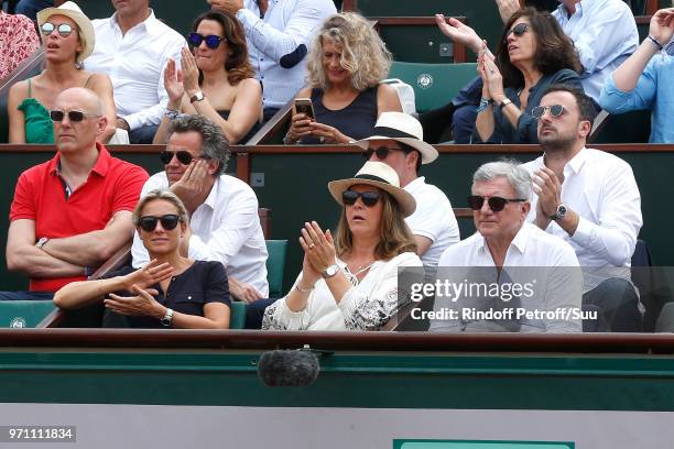 Journalist Anne-Sophie Lapix, her husband Arthur Sadoun, Sidney Toledano and his son Alan Toledano attend the Men Final of the 2018 French Open - Day...