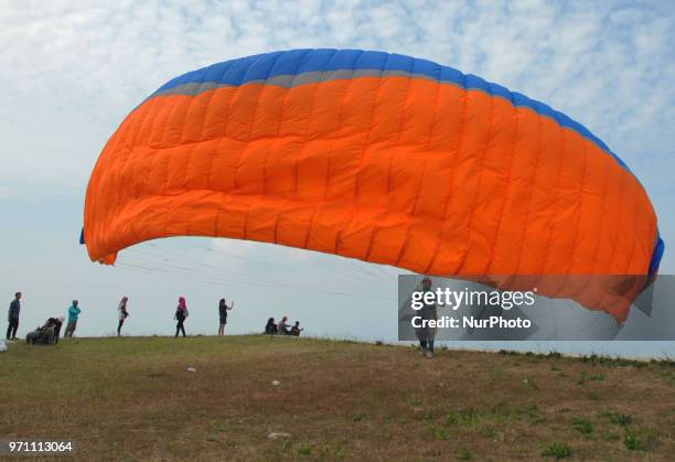 Paragliding is preparing to fly over Joglo Hill along Gajah Mungkur Reservoir, Wonogiri, Central Java Province, Indonesia on June 10, 2018. 7 Best...