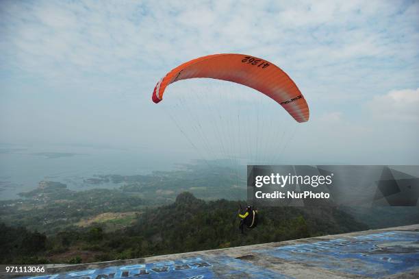 Paragliding is preparing to fly over Joglo Hill along Gajah Mungkur Reservoir, Wonogiri, Central Java Province, Indonesia on June 10, 2018. 7 Best...