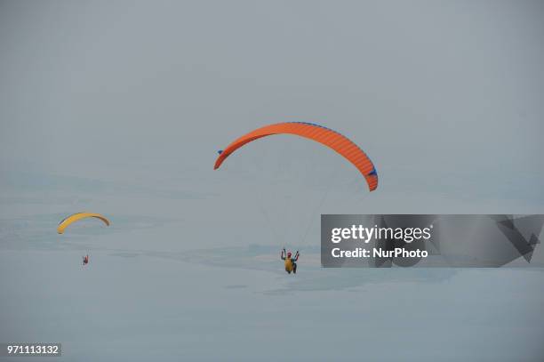 Paragliding is preparing to fly over Joglo Hill along Gajah Mungkur Reservoir, Wonogiri, Central Java Province, Indonesia on June 10, 2018. 7 Best...