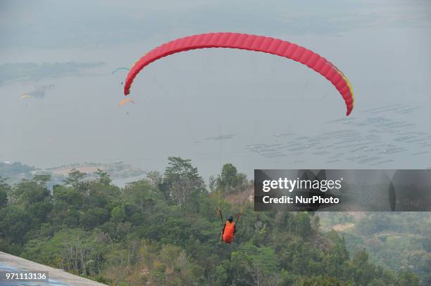 Paragliding is preparing to fly over Joglo Hill along Gajah Mungkur Reservoir, Wonogiri, Central Java Province, Indonesia on June 10, 2018. 7 Best...