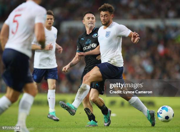 Myles Stephenson of England and Robbie Keane of the Rest of the World battle for the ball during the Soccer Aid for UNICEF 2018 match between...