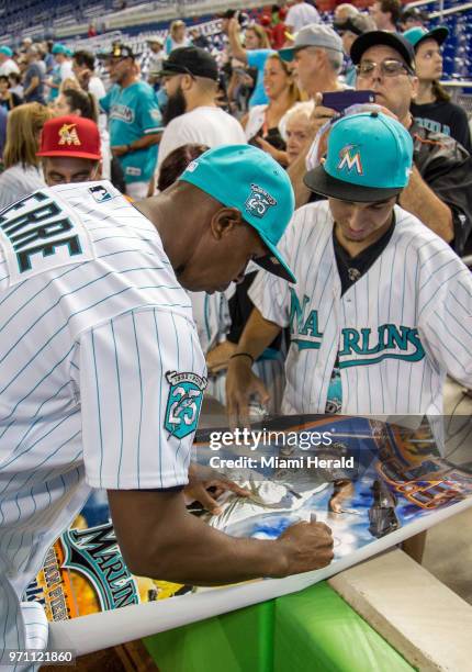 Former Miami Marlins center fielder Juan Pierre signs autographs prior today's softball game as part of the Marlins 25th anniversary weekend on...