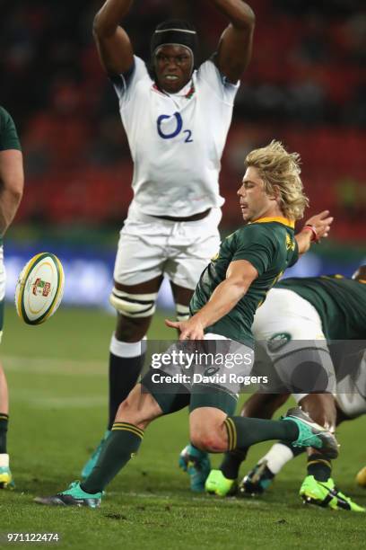 Faf de Klerk of South Africa kicks the ball past Maro Itoje during the first test match between South Africa and England at Elllis Park on June 9,...