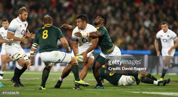 Billy Vunipola of England is tackled by Siya Kolisi during the first test match between South Africa and England at Elllis Park on June 9, 2018 in...