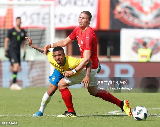 Gabriel Jesus of Brazil fights for a ball with Sebastian Prodl of Austria during an International Friendly match at Ernst Happel Stadium on June 10,...