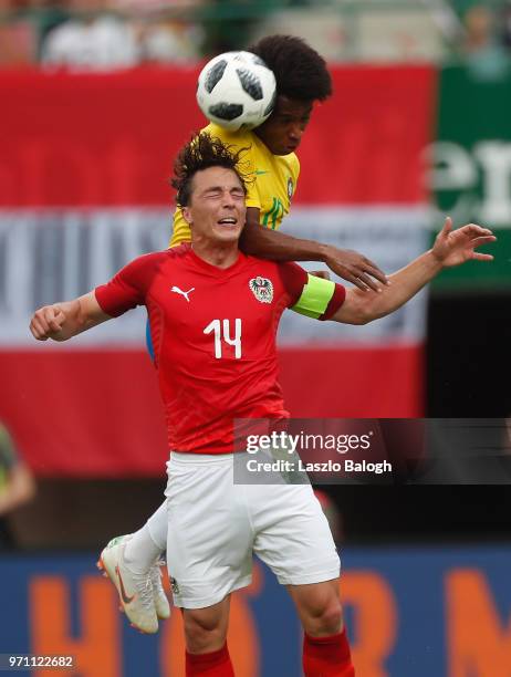 Willian of Brazil fights for a ball with Julian Baumgartlinger of Austria during an International Friendly match at Ernst Happel Stadium on June 10,...