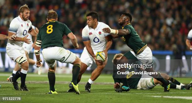 Billy Vunipola of England is tackled by Siya Kolisi during the first test match between South Africa and England at Elllis Park on June 9, 2018 in...