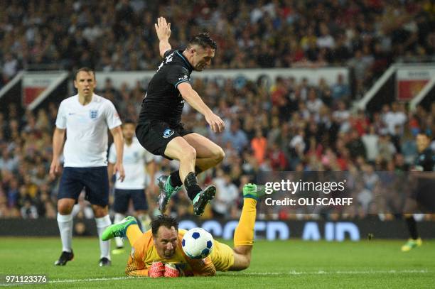 Ireland's Robbie Keane scores past England's David Seaman during an England V Soccer Aid World XI charity football match for Soccer Aid for Unicef at...