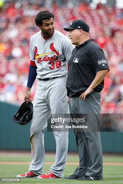 Jose Martinez of the St. Louis Cardinals talks to an umpire during a replay review in the third inning against the Cincinnati Reds at Great American...