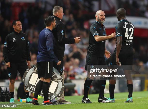 Eric Cantona of the Rest of the World replaces Yaya Toure of the Rest of the World as substitute during the Soccer Aid for UNICEF 2018 match between...