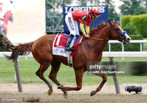 Justify, ridden by Jockey Mike Smith, is pictured just after crossing the finish line during the 150th running of the Belmont Stakes on June 9, 2018...