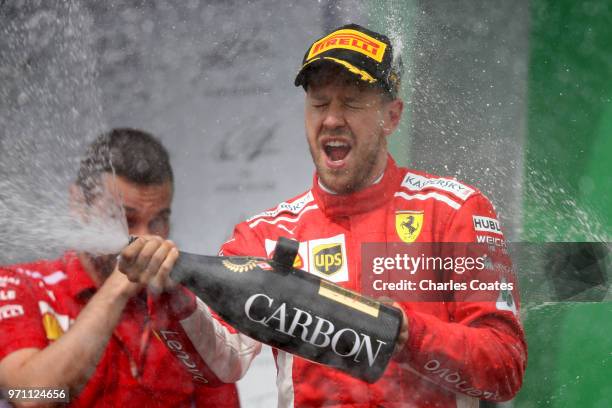 Race winner Sebastian Vettel of Germany and Ferrari celebrates on the podium during the Canadian Formula One Grand Prix at Circuit Gilles Villeneuve...