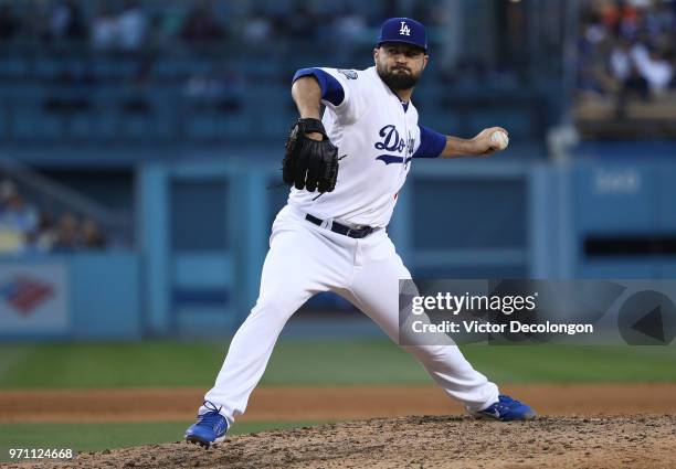 Pitcher Adam Liberatore of the Los Angeles Dodgers pitches in the seventh inning during the MLB game against the Miami Marlins at Dodger Stadium on...