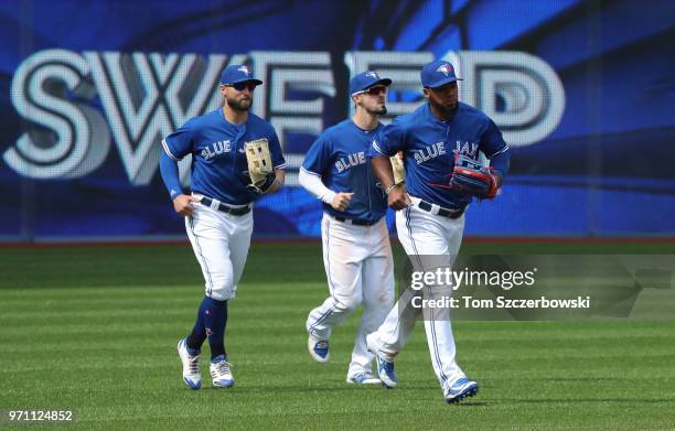 Teoscar Hernandez of the Toronto Blue Jays and Randal Grichuk and Kevin Pillar celebrate their sweep during MLB game action against the Baltimore...