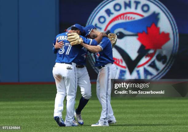 Teoscar Hernandez of the Toronto Blue Jays and Randal Grichuk and Kevin Pillar celebrate their sweep during MLB game action against the Baltimore...