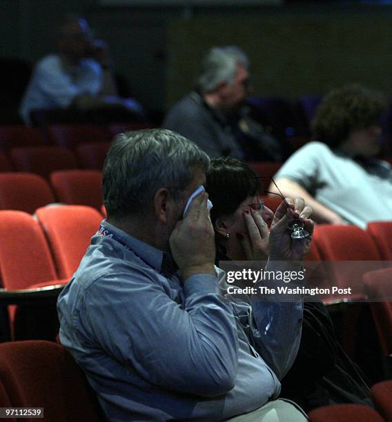 Jahi chikwendiu Bruce Walter, left, and his wife Kathleen Walter wipe their teary eyes as people gather to watch television coverage of the Pope's...