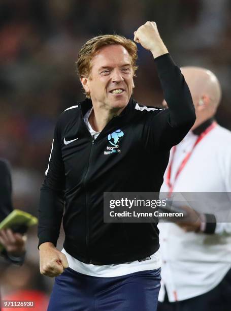 Damian Lewis of England celebrates a successful penalty in the shoot out during the Soccer Aid for UNICEF 2018 match between Englannd and the Rest of...