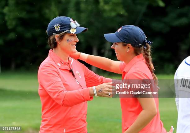 Kristen Gillman of the United States is congratulted by her captain Virginia Derby Grimes after Gillman had won her match against Annabell Fuller of...