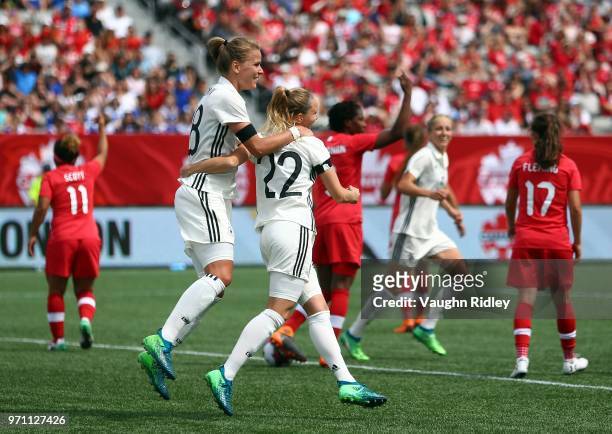 Turid Knaak of Germany celebrates a goal with Lena Petermann during the second half of an International Friendly match against Canada at Tim Hortons...