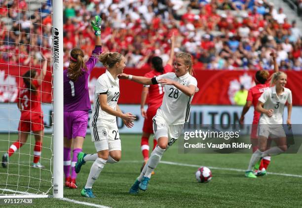 Turid Knaak of Germany celebrates a goal with Lena Petermann during the second half of an International Friendly match against Canada at Tim Hortons...