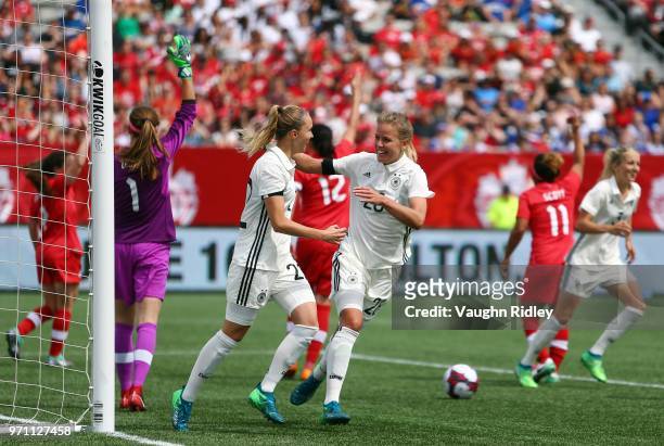 Turid Knaak of Germany celebrates a goal with Lena Petermann during the second half of an International Friendly match against Canada at Tim Hortons...