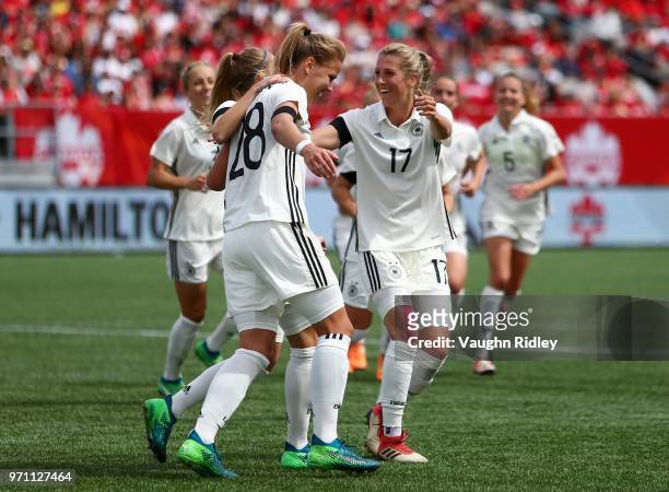 Turid Knaak of Germany celebrates a goal with Lena Petermann and Verena Faibt during the second half of an International Friendly match against...