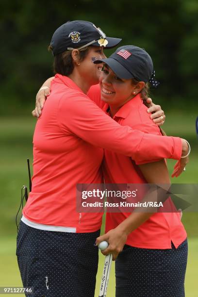 Kristen Gillman of the United States team and Captain Virginia Derby Grimes celebrate a match-winning point on the 14th green during the singles...