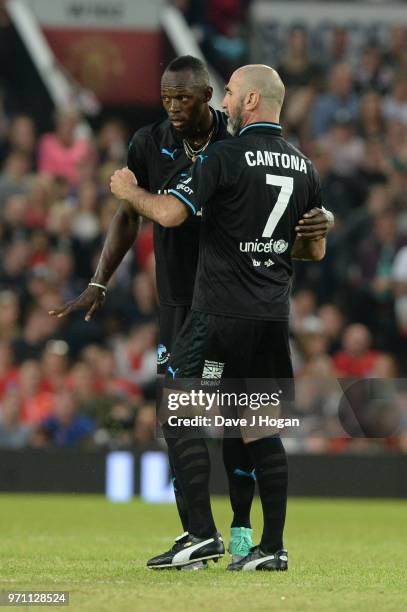 Eric Cantona speaks with Usain Bolt during Soccer Aid for Unicef 2018 at Old Trafford on June 10, 2018 in Manchester, England.