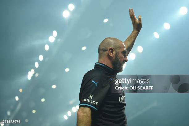 France's Eric Cantona waves after an England V Soccer Aid World XI charity football match for Soccer Aid for Unicef at Old Trafford in Manchester,...