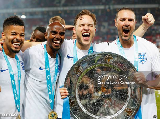 Jeremy Lynch, Sir Mo Farah, Olly Murs and Paddy McGuinness of England celebrate victory with the trophy after the Soccer Aid for UNICEF 2018 match...