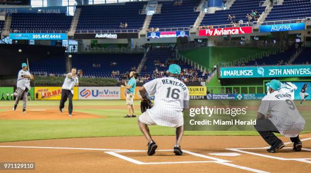 Former Miami Marlins Livan Hernandez and Mike Lowell throw the ceremonial first pitch of the game to Edgar Renteria and Juan Pierre prior today's...