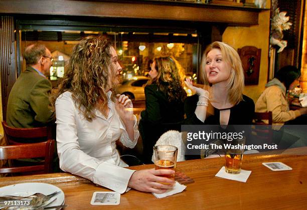 Corner Photos by Michael Williamson NEG#174476 11/10/05 -- Meghan Ely and Ronda McCarthy enjoy an after work brew at Cafe Saint-Ex at 14th and T sts.
