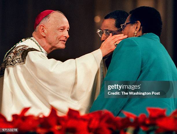 Archbishop Theodore McCarrick greets Ira and Judy Chase of Washington, D.C. During the ceremony at the Basilica of the National Shrine of the...