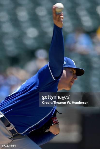 Brad Keller of the Kansas City Royals pitches against the Oakland Athletics in the bottom of the first inning at the Oakland Alameda Coliseum on June...