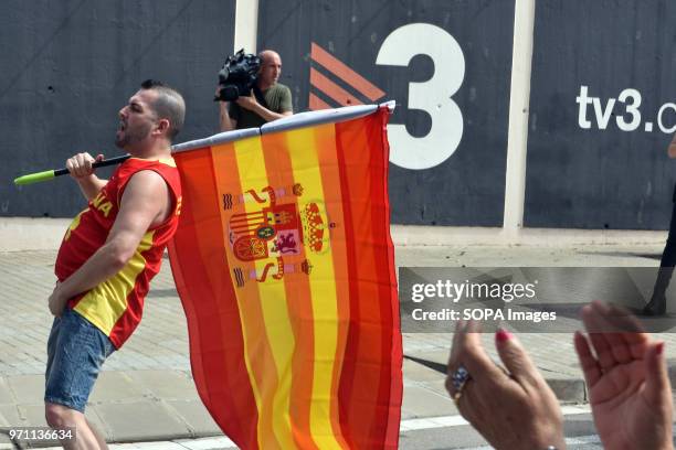 Man with a Spanish flag makes an obscene gestures to the police during the demonstration. Hundreds of people, fans and groups of the ultra right like...