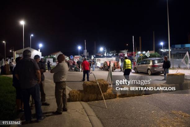 French National federation of Agricultural Holders' Unions and Young Farmers union members demonstrate as they block the access of French oil giant...