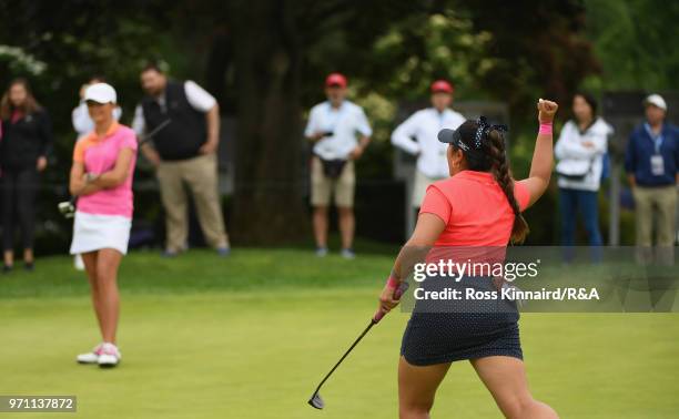 Lilia Vu of the United States team celebrates making a birdie on the 18th green as Sophie Lamb of the Great Britain and Ireland team looks on during...